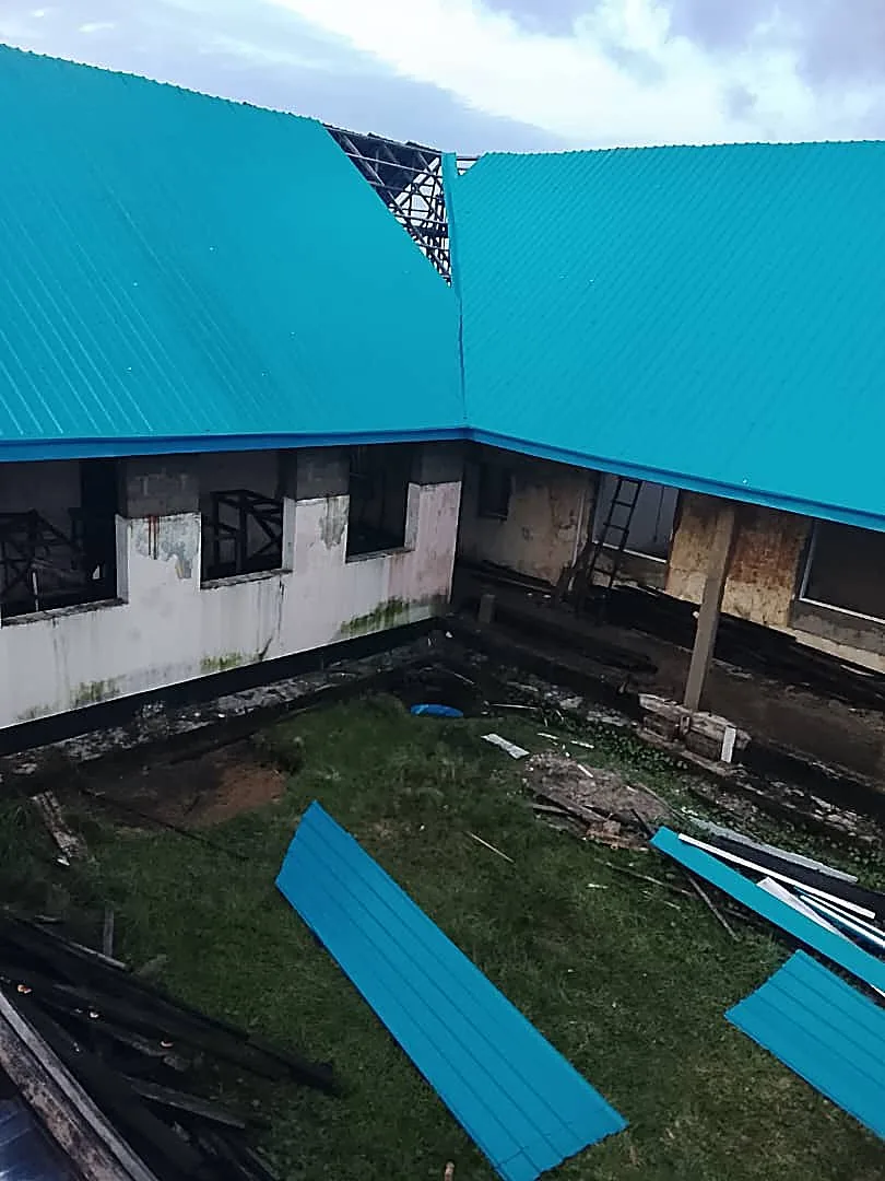 Commercial building corner, blue roof going up