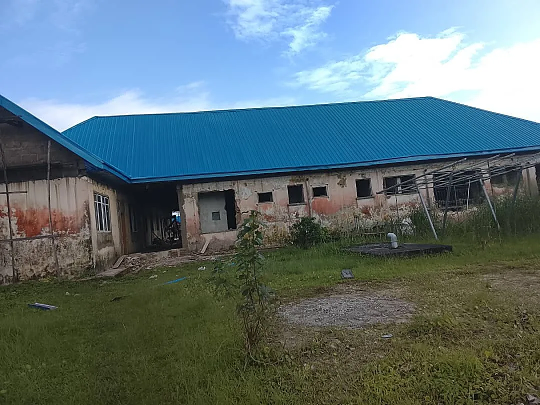 Long institutional building, blue roof stage