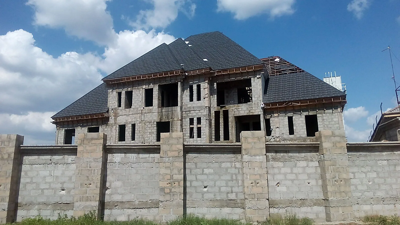 Mansion-scale duplex, tile roof in progress